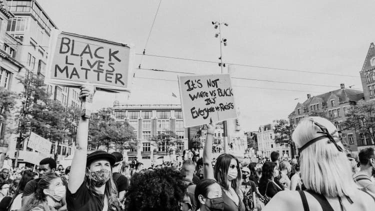 BLM protestors holding up protest signs